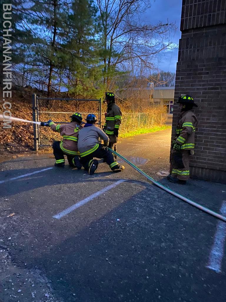 Members practicing hose line advancement 